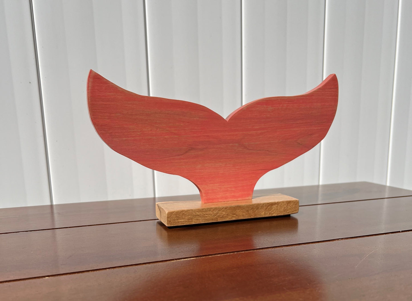 Coral Whale Tail Statue on oak base.