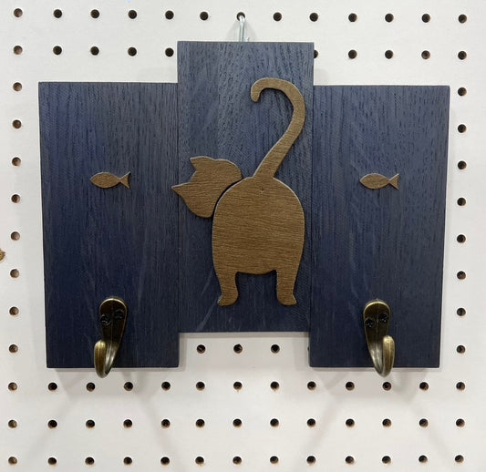 Brown Cat Butt on Navy Blue wood planks with hooks